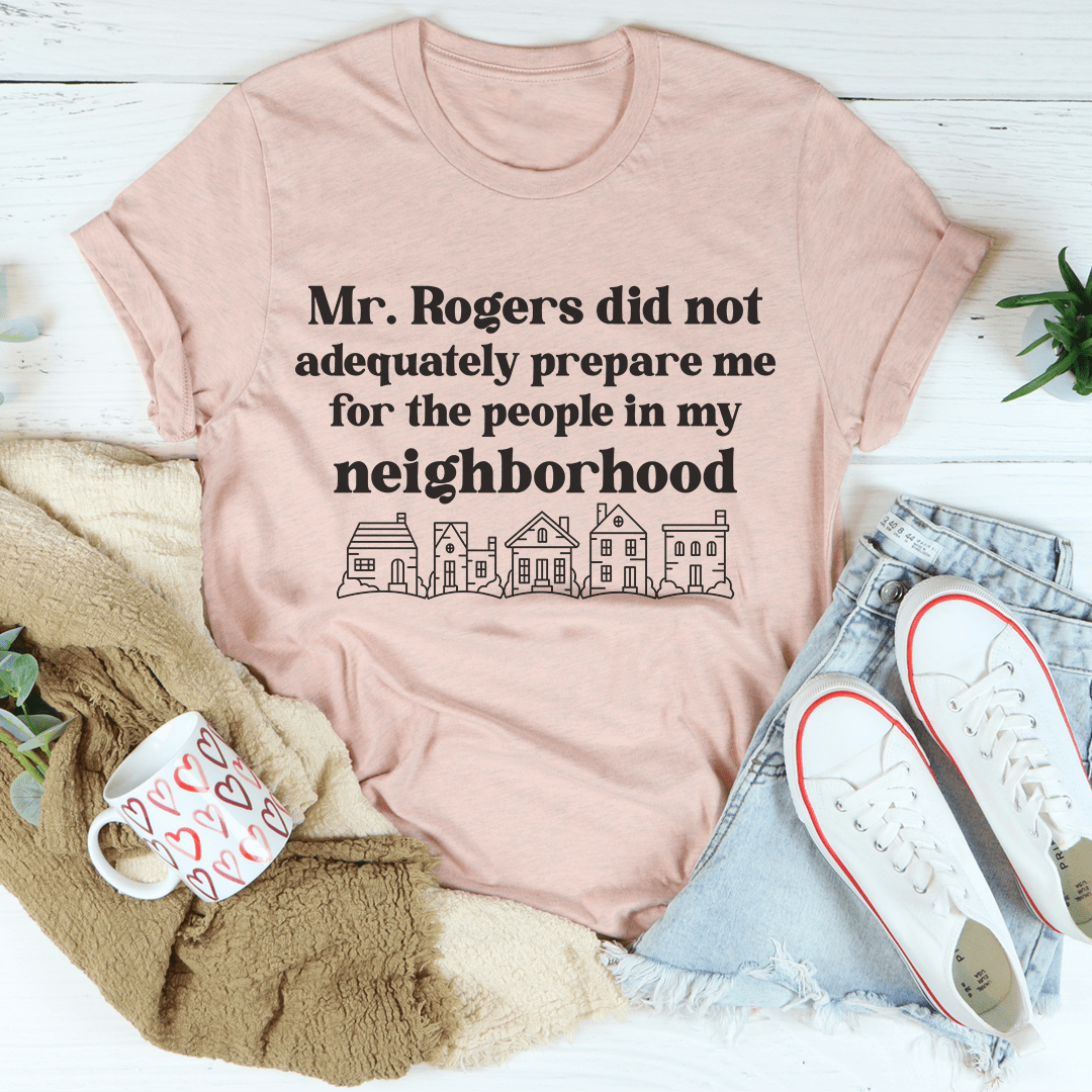 Peach crew-neck T-shirt with town-line graphic and "Mr. Rogers..." text