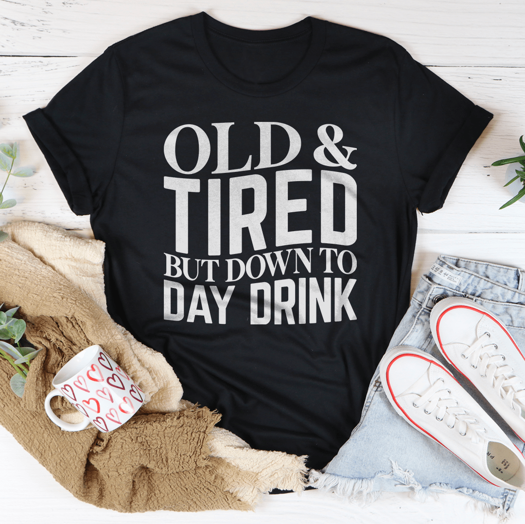 Black crewneck T-shirt with centered "OLD & TIRED" "BUT DOWN TO DAY DRINK" print.