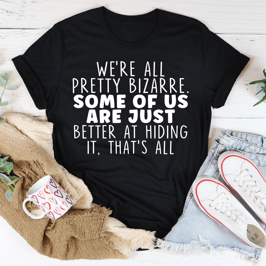 Black short-sleeve crewneck T-shirt with centered white quote text, “pretty bizarre”.