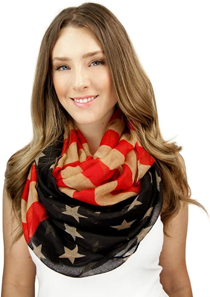 Infinity scarf looped around model’s neck with red-and-cream stripes and black star print