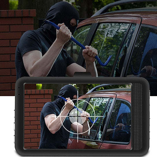 Car dash cam screen showing wired rear camera view while person adjusts mount