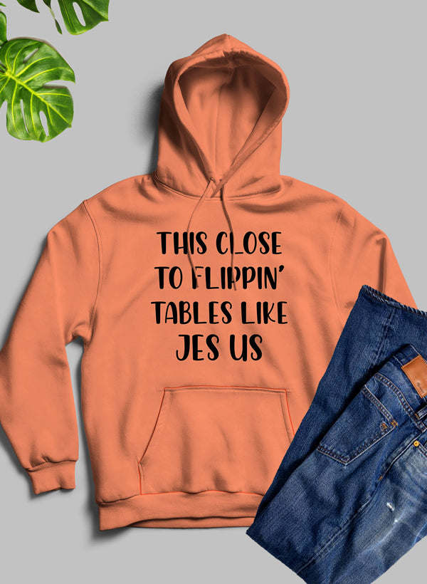 Orange hoodie with hood, kangaroo pocket, and centered chest text graphic