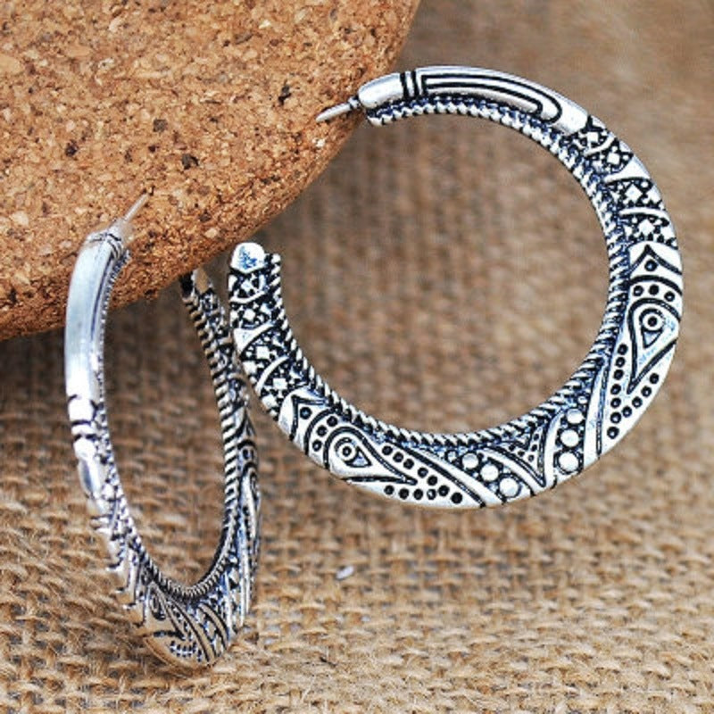 Silver-tone stud hoop earrings with engraved crescent pattern and dot accents