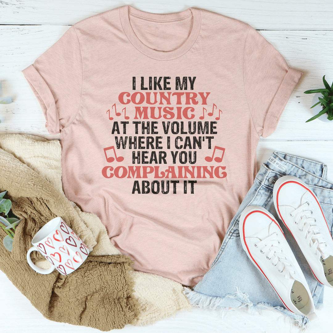 Light pink graphic country music T-shirt with red and black text, short sleeves
