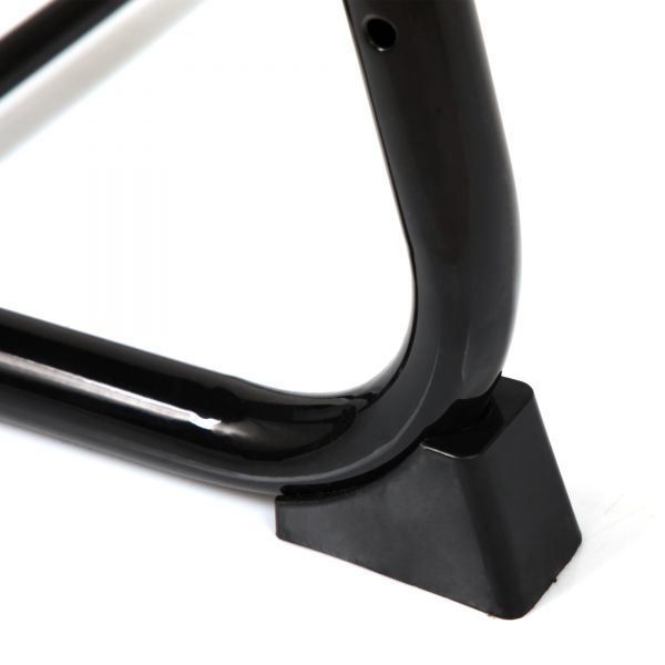 Close-up of black table leg foot and curved support frame