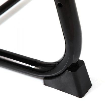 Close-up of black table leg foot and curved support frame