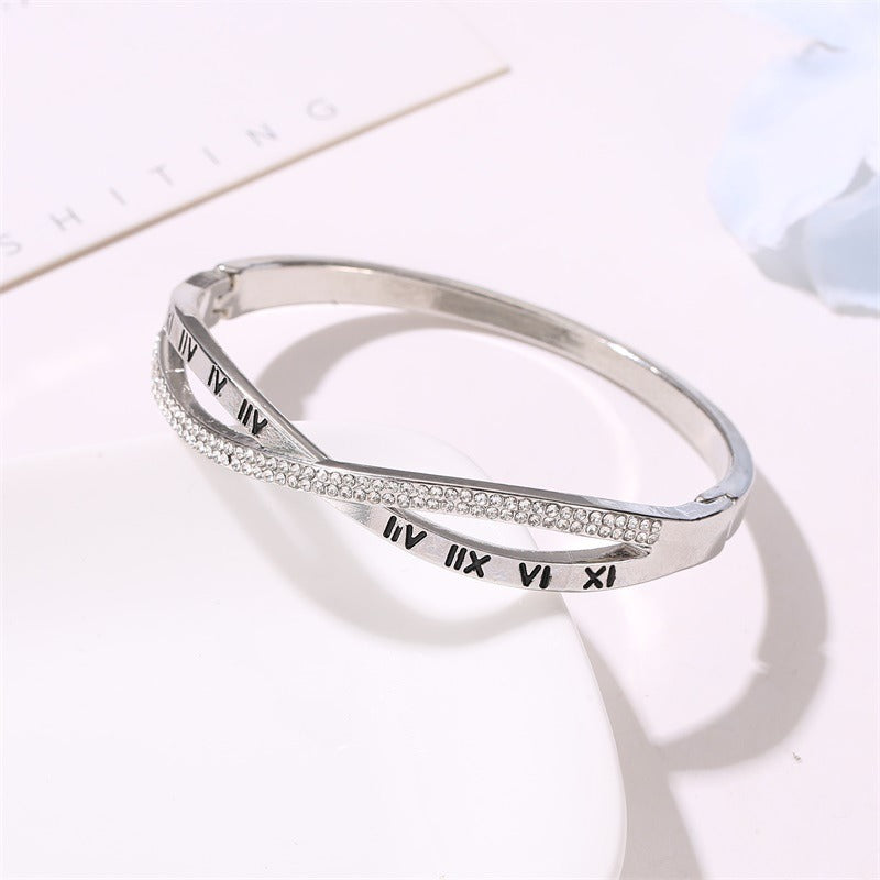 Silver-tone roman numeral bracelet bangle with rhinestone-embellished edge and etched numerals