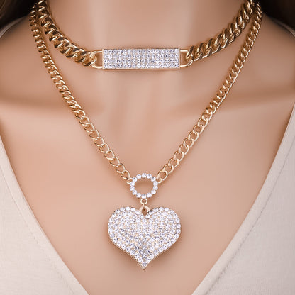 Gold double-layer chain necklace with rectangular crystal bar and heart charm