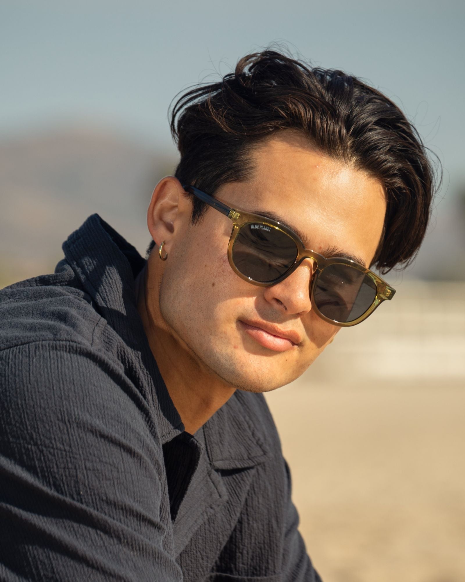 Olive green polarized sunglasses on face, dark round lenses and full frame