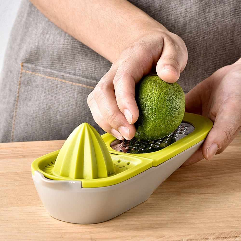 Green citrus juicer grater with cone reamer; hands squeezing a whole fruit