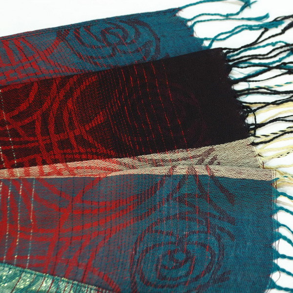 Pashmina shawl corner detail with teal and red woven design and fringe