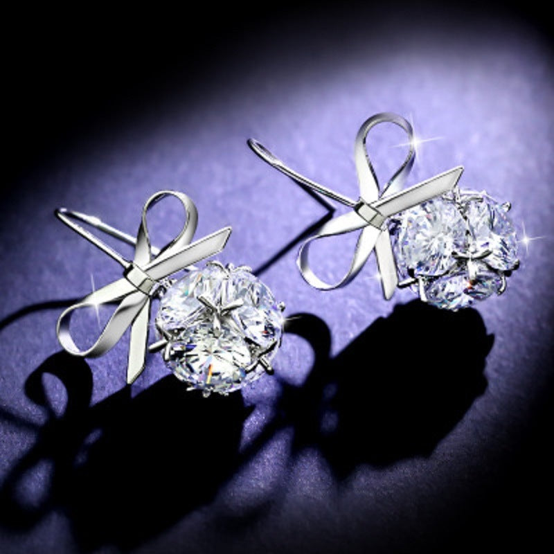 Silver-tone bow earrings with ribbon design and large round zircon sparkle stones
