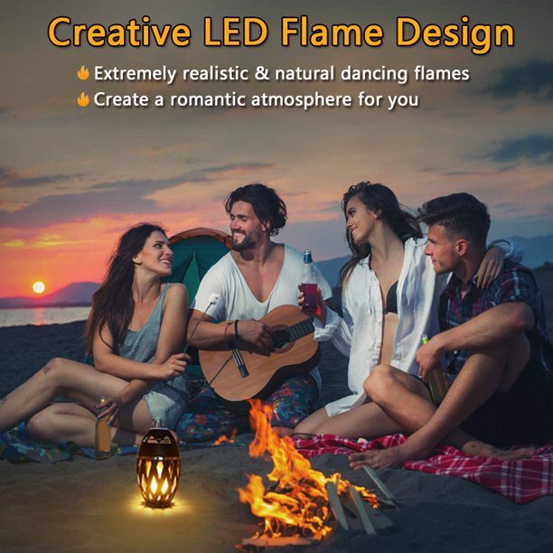 Outdoor LED torch light with black lantern body and glowing amber flame-pattern on ground.