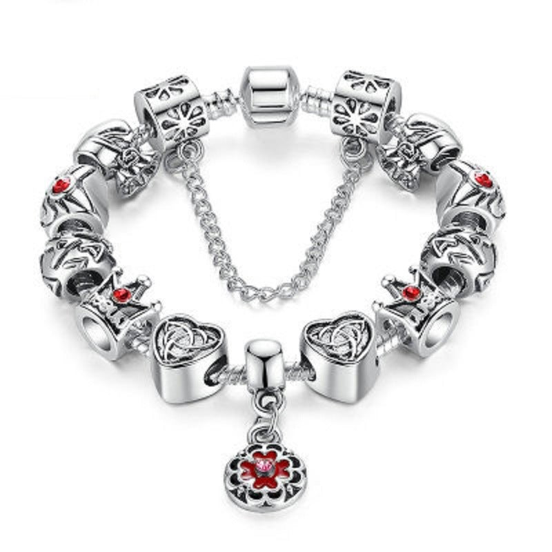 Silver charm bracelet with red enamel flower and heart charms, linked chain and clasp