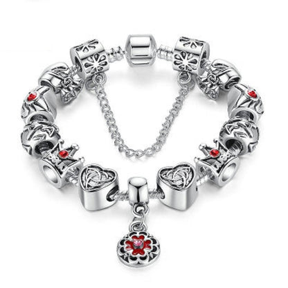 Silver charm bracelet with red enamel flower and heart charms, linked chain and clasp