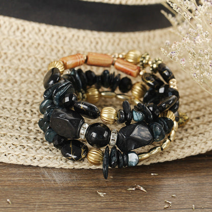 Boho multilayer bracelet with black beads, gold spacer beads, and rhinestone accents