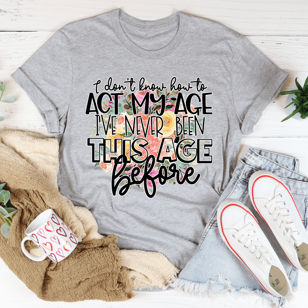 Gray crewneck graphic T-shirt with 'act my age' slogan in bold script