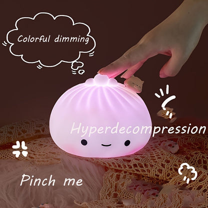 Purple glowing silicone dumpling night light with round face and small pig charm on top