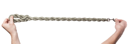 Woven dog leash with braided rope and metal clasp, held by hands