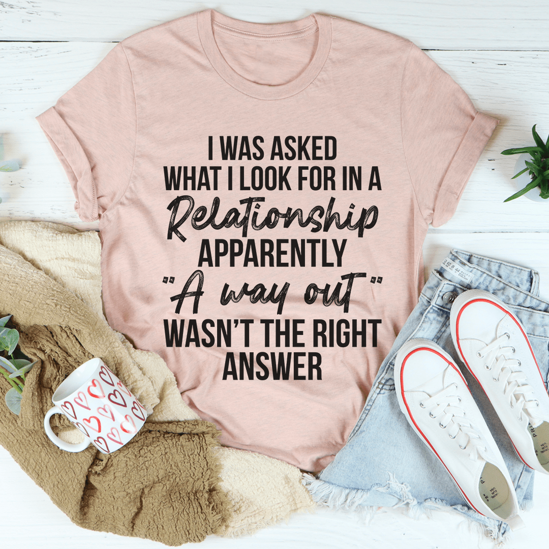 Light rose-pink crewneck T-shirt with bold relationship quote graphic reading “I was asked…”