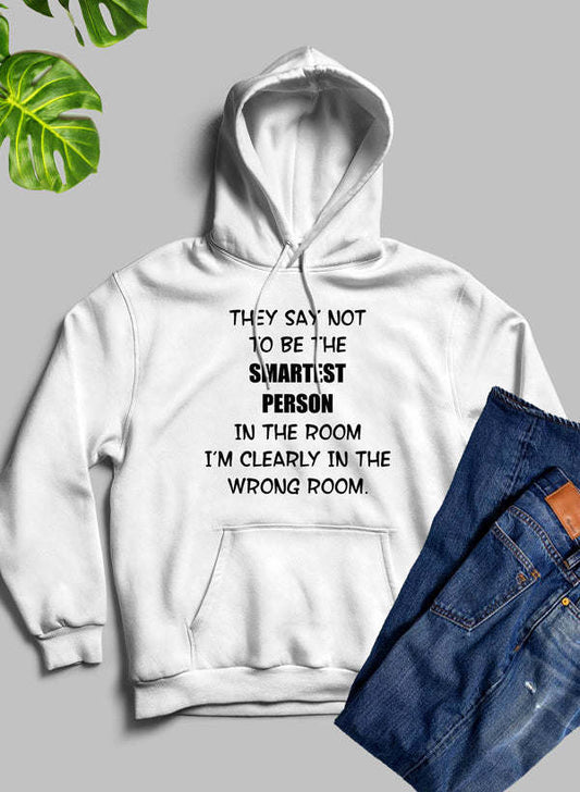 White hoodie with hood, front pocket, and bold quote graphic on chest.