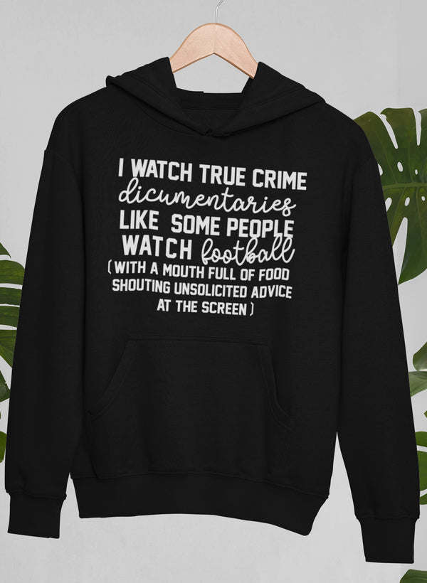 Black pullover hoodie with hood and front pocket, featuring a bold text graphic.