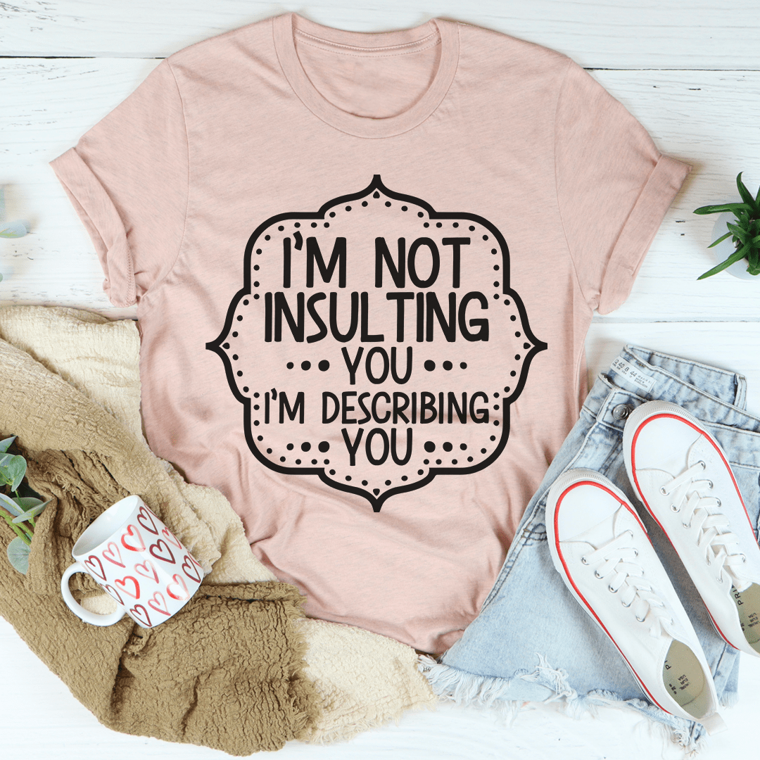 Light pink T-shirt with black quote text: “I'm not insulting you; I'm describing you”