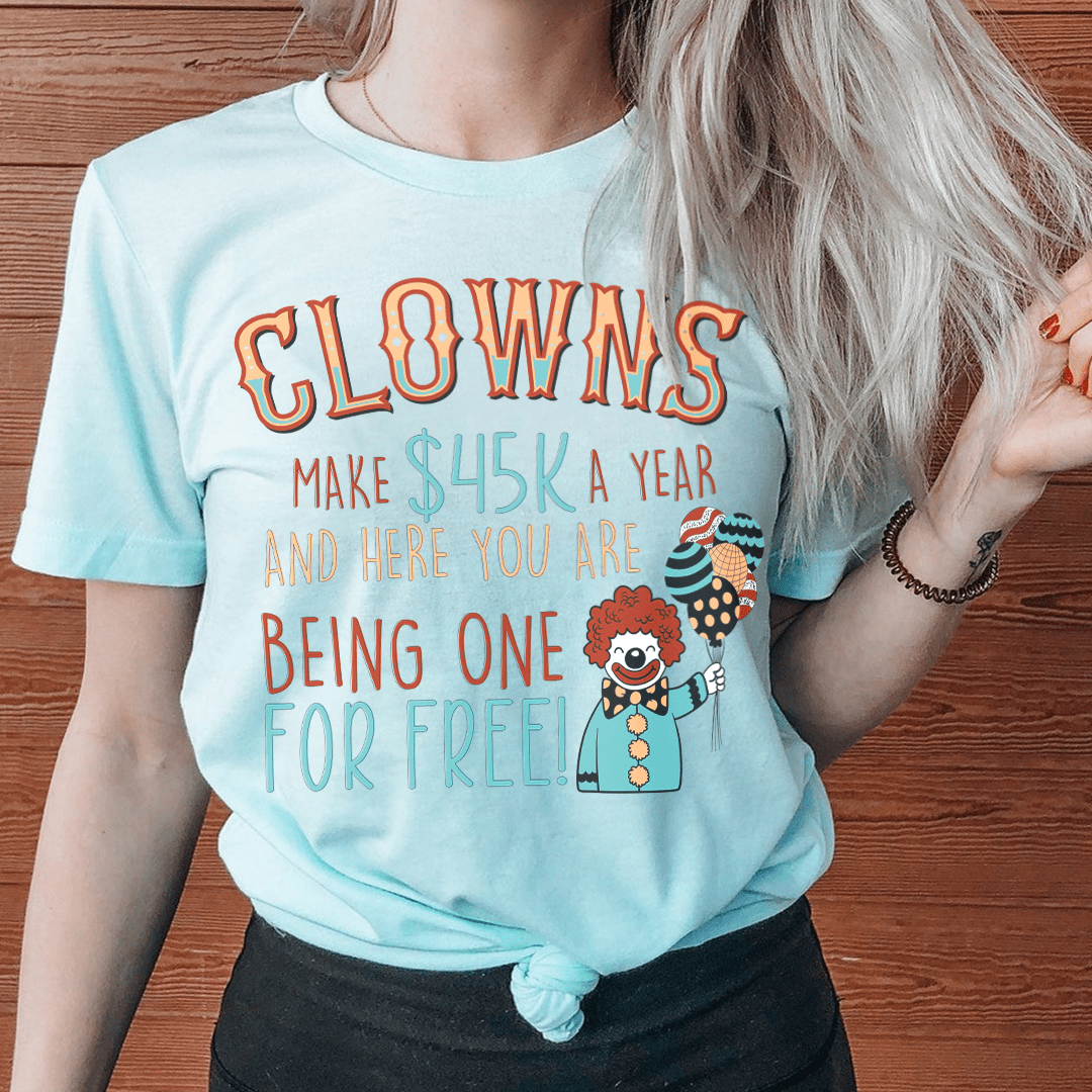Light blue T-shirt with large clown graphic and multicolor text on front
