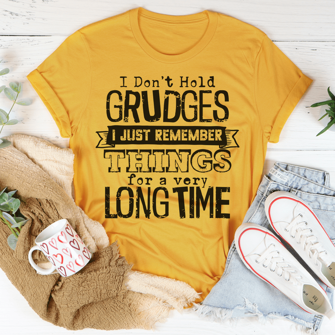 Mustard yellow crewneck T-shirt with bold quote graphic reading “GRUDGES”