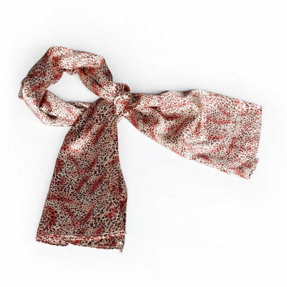Leopard print silk scarf in warm pink, draped with long ends
