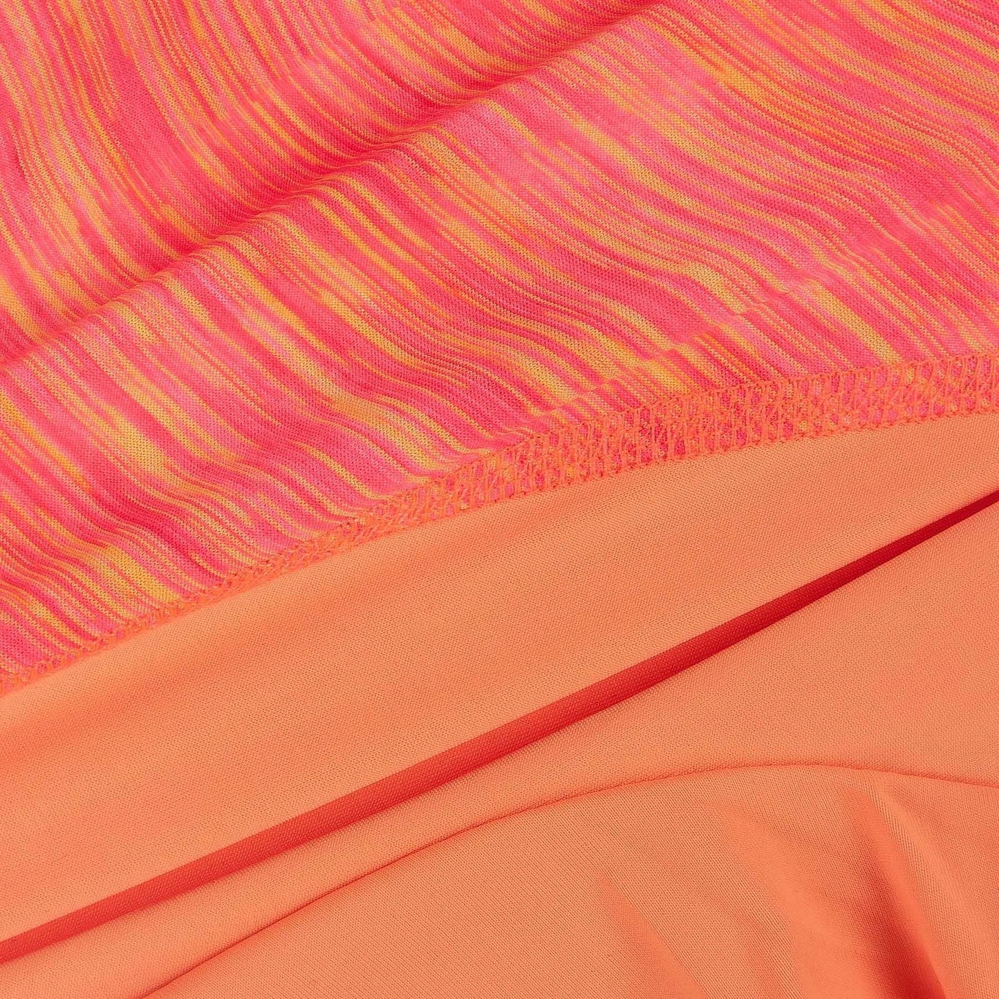 Orange-red heather performance fabric close-up with seam and inner layer panel