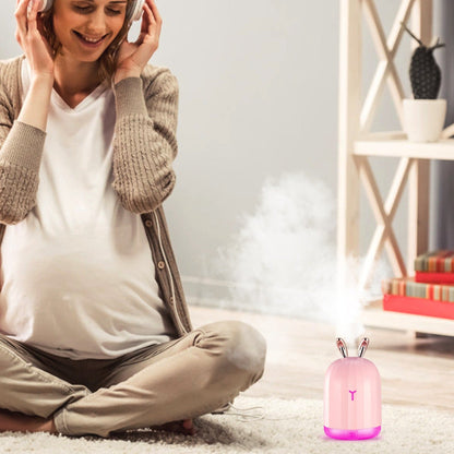 Pink bunny cool mist humidifier emitting mist with pink glowing base light