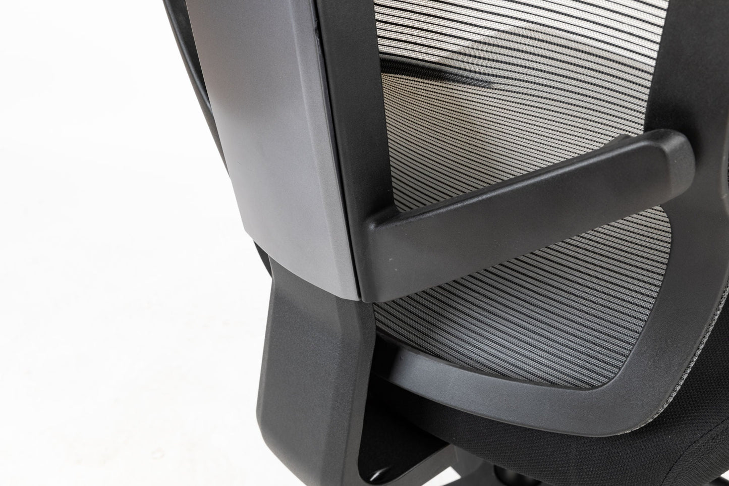 Black office chair close-up of side mesh back and molded armrest