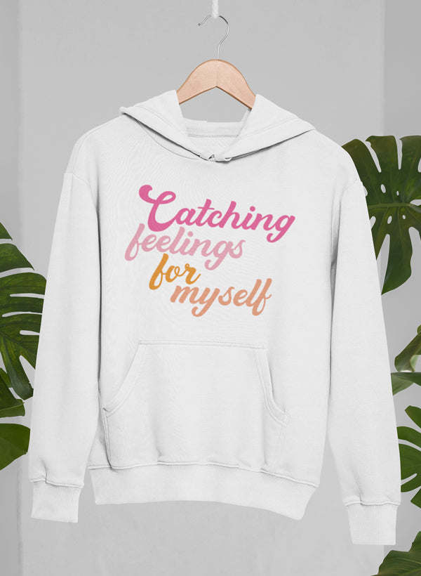 White Catching Feelings pullover hoodie with multicolor front text and kangaroo pocket