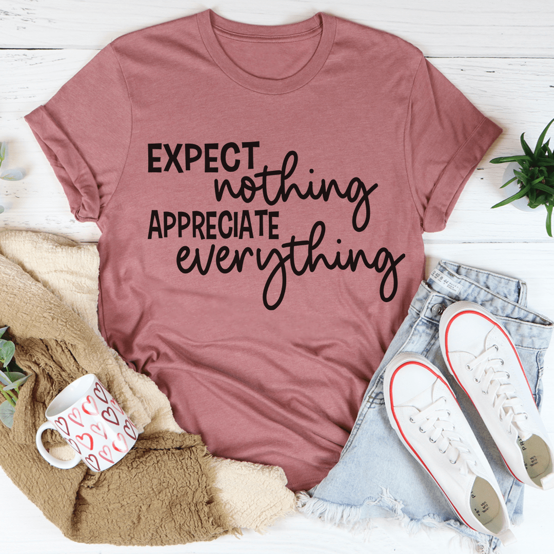 Dusty rose crewneck t-shirt with centered white-and-black typographic slogan