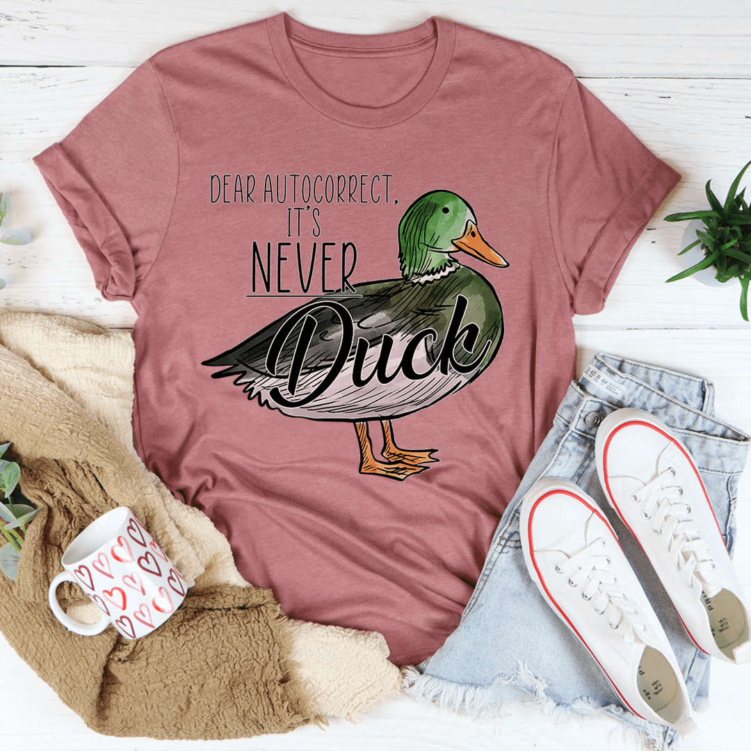 Mauve T-shirt with green duck graphic and 'Never' slogan text, crew neck.