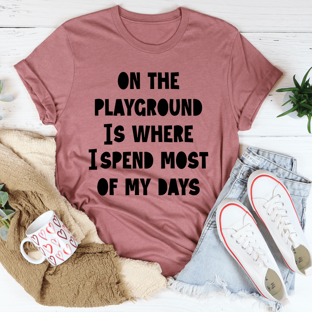 Mauve crewneck T-shirt with bold black "ON THE PLAYGROUND..." text design