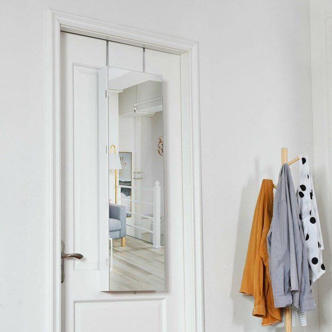 Mirrored jewelry cabinet with door open, showing light interior storage shelves
