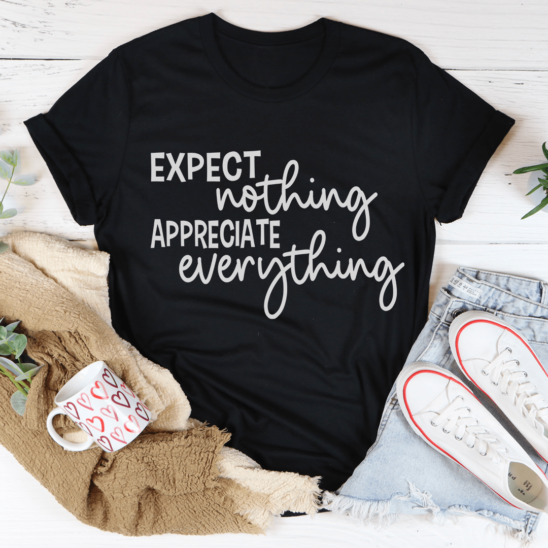 Black crew-neck T-shirt with white 'Expect nothing appreciate everything' slogan design
