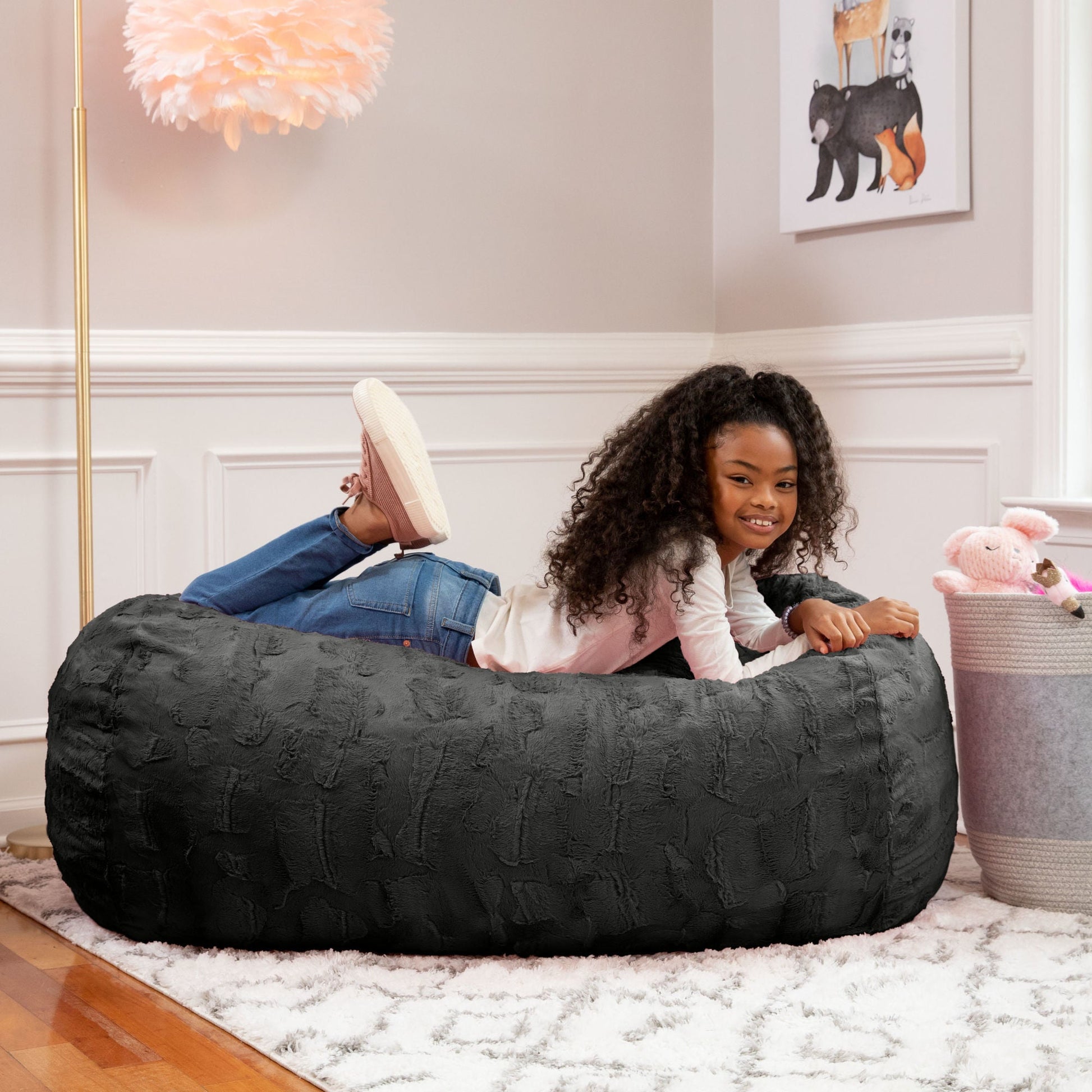 Black bean bag couch with textured fabric cover, rounded bolster shape
