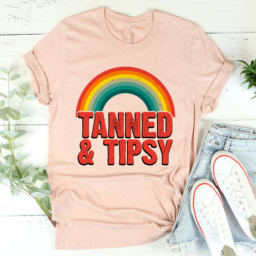 Light pink crewneck T-shirt with rainbow arc graphic and bold red-and-black text print