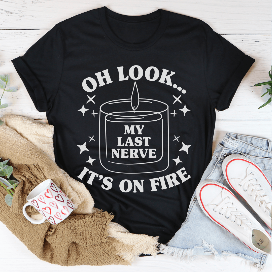 Black T-shirt with front candle graphic and “OH LOOK… IT’S ON FIRE” text