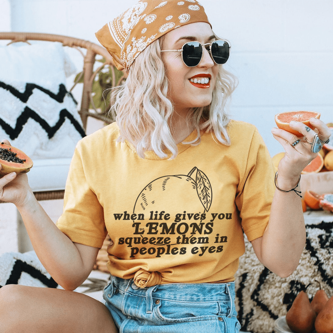 Yellow crewneck T-shirt with lemon graphic and slogan text 'when life gives you LEMONS'