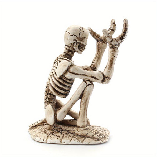 Resin skeleton pen holder, seated pose with detailed ribcage and raised arms