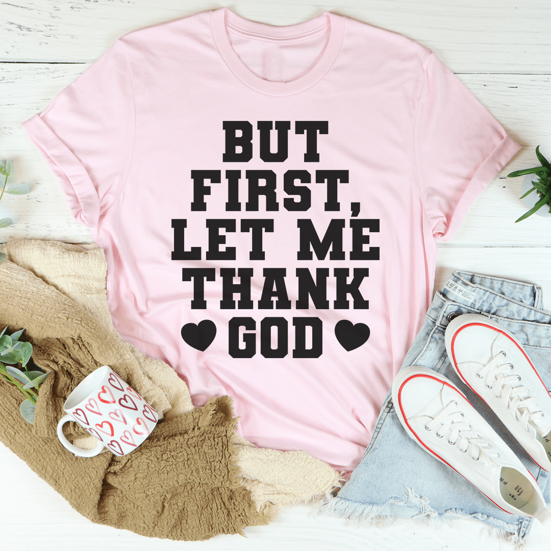 Pink T-shirt with black "But First, Let Me Thank God" text and heart icons