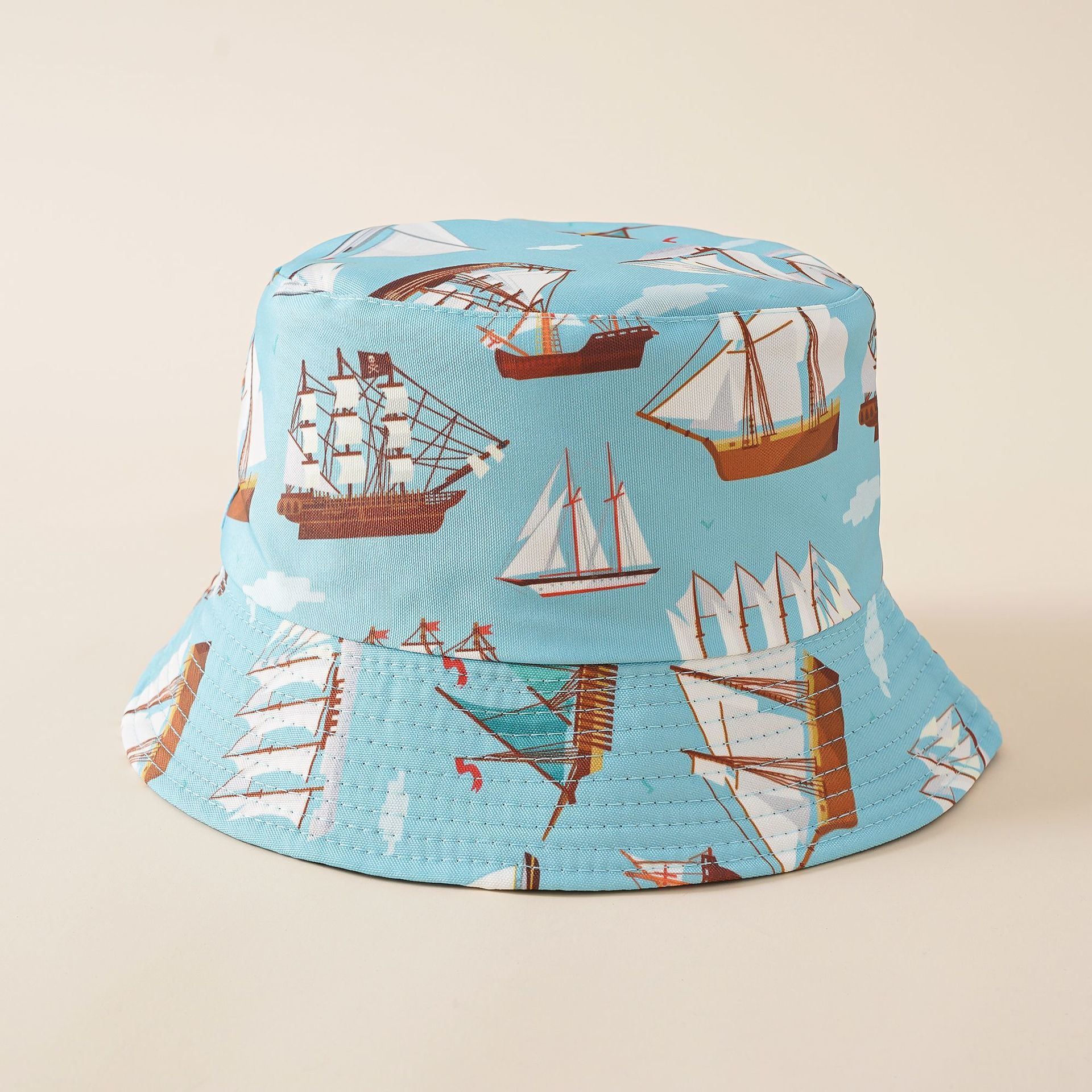 Light blue fisherman bucket hat with sailboat and ship illustration print, wide brim