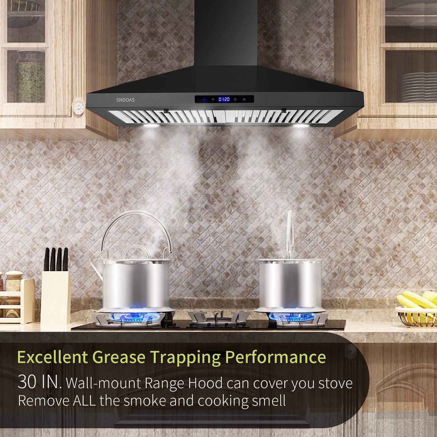 Black vent hood above cooktop with chimney housing and stainless baffle filter