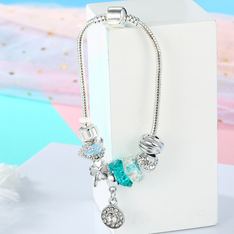 Silver charm bracelet with blue crystal beads and round rhinestone heart dangling charm
