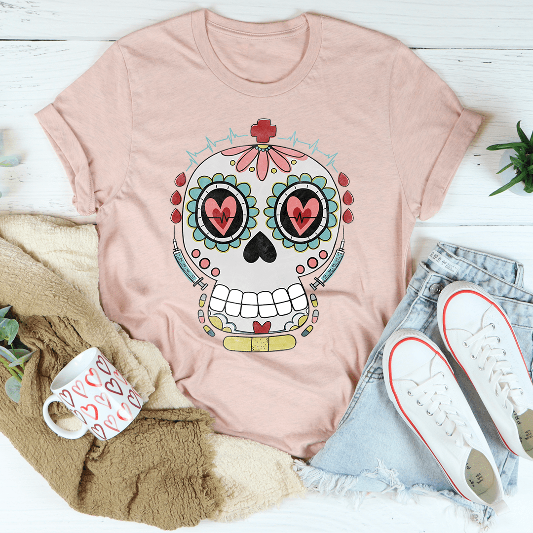 Dusty pink T-shirt with nurse sugar skull graphic and heart-eyed face on chest