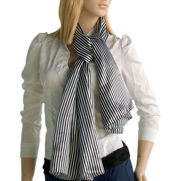 Black and white striped scarf worn with tied bow, fringed ends